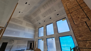 Interior of a new construction home with drywall installation and taping in progress by Acosta Painting LLC in Jonesboro, AR.