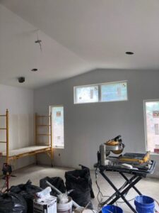 Drywall installation and renovation with scaffolding and tools by Farnsworth Interiors Drywall and Plaster in Akron, OH