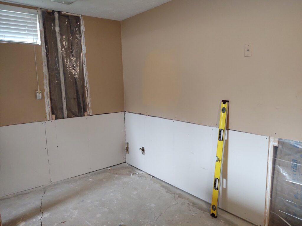 Partial drywall installation and repair in a room, showcasing services by IFixdIt Handyman Services in Omaha, NE.