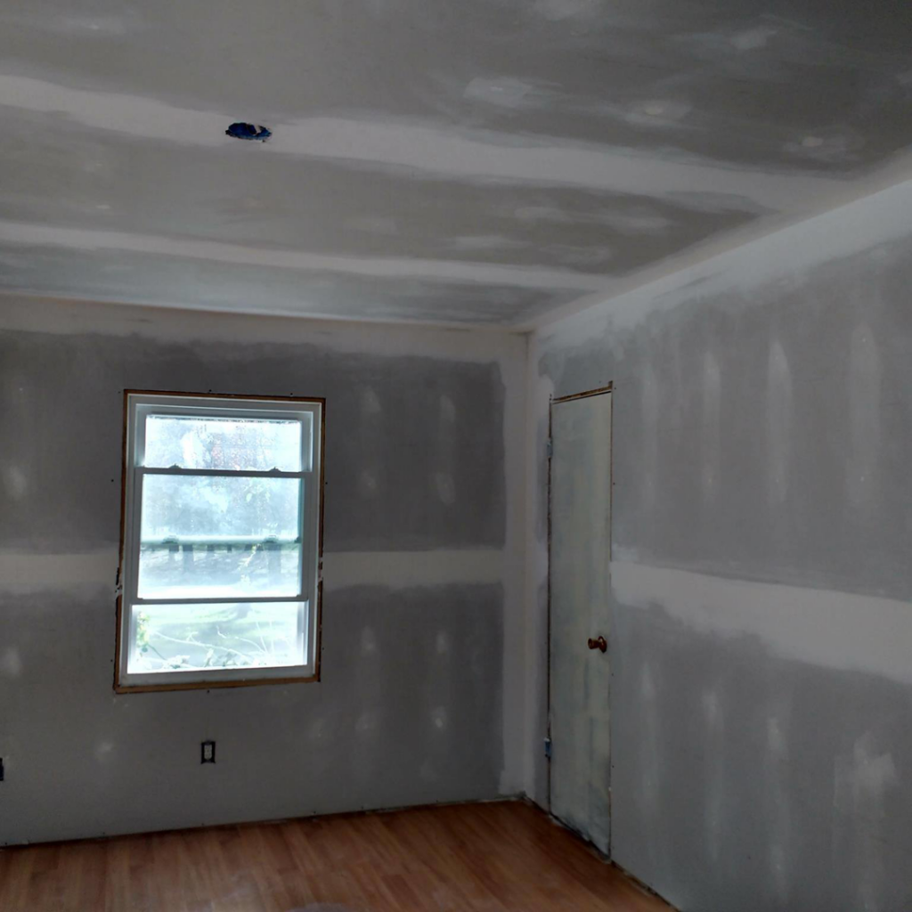A room with new drywall installed and mudded, ready for painting by D&B Drywall in Canton, OH.