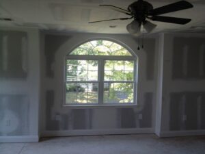 An interior room with new drywall installed, awaiting finishing by EK Construction, LLC in Philadelphia, PA