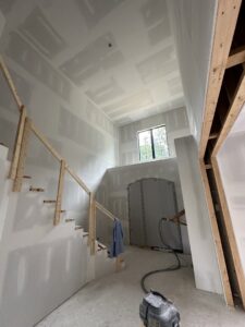 Drywall installation in progress on walls and ceiling around a staircase at a home by Hahn Brothers Drywall Co Inc in Evansville, IN