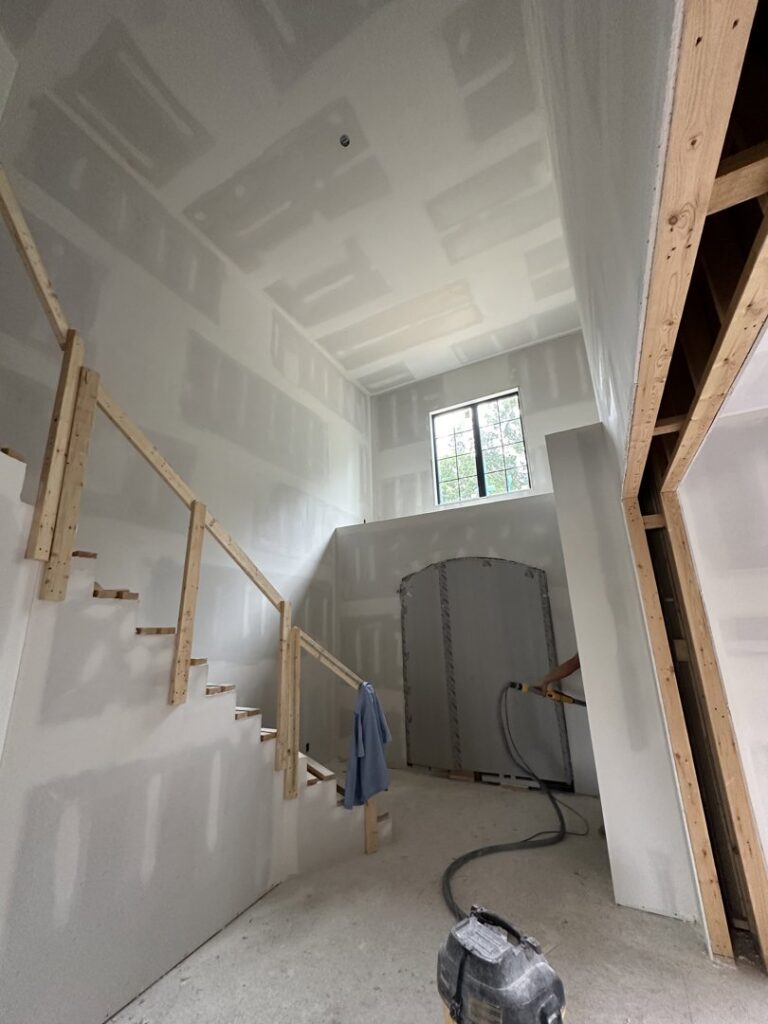 Drywall installation in progress on walls and ceiling around a staircase at a home by Hahn Brothers Drywall Co Inc in Evansville, IN