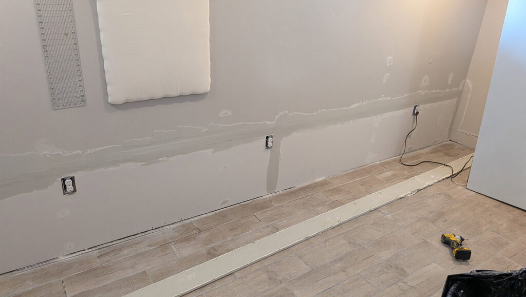 Drywall mudding and taping in progress on an interior wall by SurePlan Handyman in North Ogden, UT