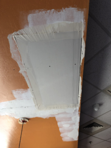 Drywall patch on an orange wall and ceiling corner, taped and mudded by Fonseca's Drywall, LLC in Glendale, AZ