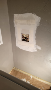 Drywall patch and repair work in progress on a wall by M&M Drywall and Construction in Enid, OK