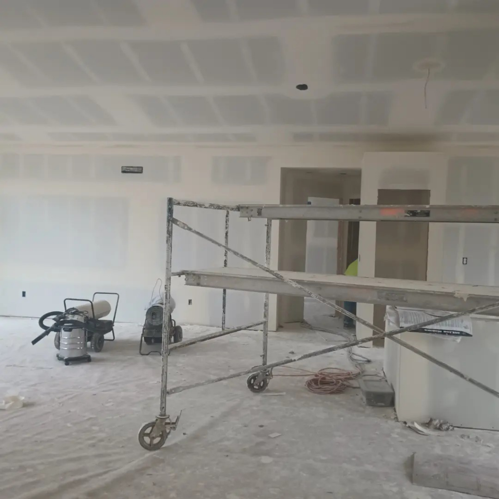 A drywall project in progress with scaffolding and equipment, handled by JLSL Drywall LLC in Salem, OR.