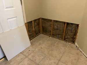 Drywall removed exposing insulation and studs for repair by San Marcos Drywall and Paint in Austin, TX