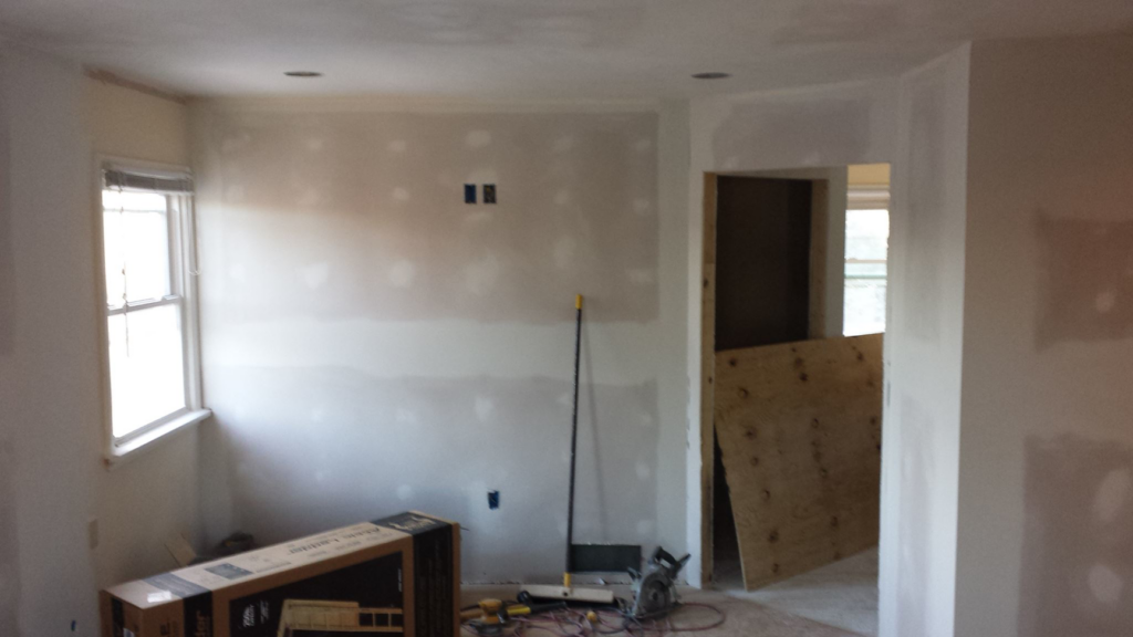 Drywall repair and painting preparation in a room, showcasing handyman work by Precision Painters in Louisville, KY