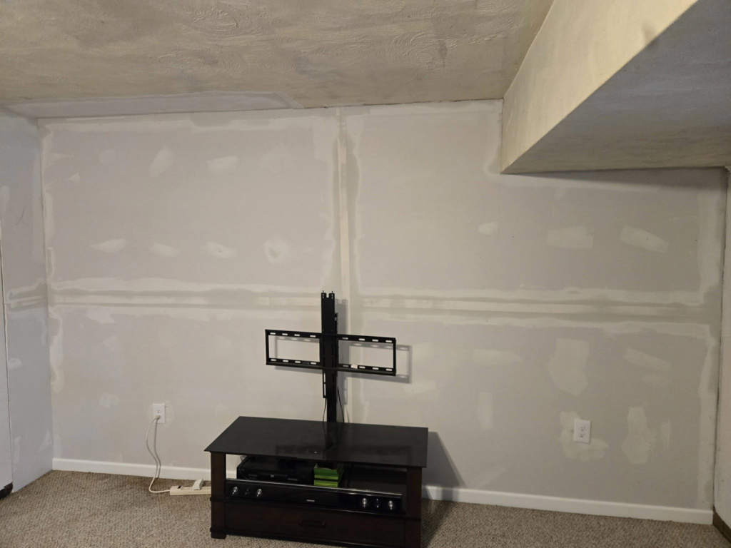 A wall showing drywall repair and installation with mudding by Sure Can LLC Handyman Services in South Charleston, WV.