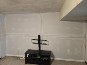 A wall showing drywall repair and installation with mudding by Sure Can LLC Handyman Services in South Charleston, WV.