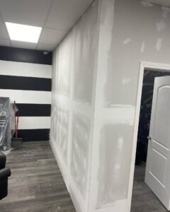 Drywall repair and mudding in progress on a wall, showcasing work by In Goode Hands LLC in Beckley, WV.