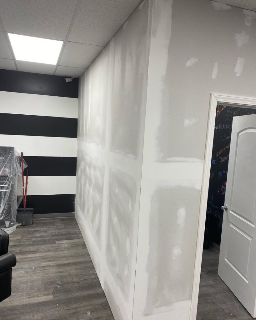 Drywall repair and mudding in progress on a wall, showcasing work by In Goode Hands LLC in Beckley, WV.