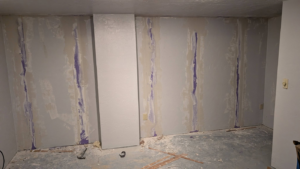 A wall showing drywall repair and patching work in progress by GCB Home Improvement in Appleton, WI.