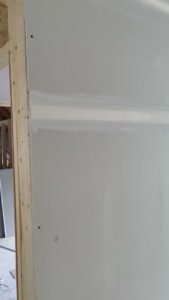 A close-up of a perfectly taped and mudded drywall seam, demonstrating quality finishing by New England Drywall in Springfield, MA.