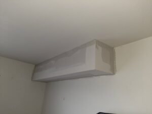 A newly installed and finished drywall soffit on a ceiling by HandyVets in Saint Charles, MO.