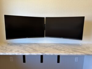 Dual computer monitors professionally wall-mounted above a desk by HandyMan of NWA in Rogers, AR