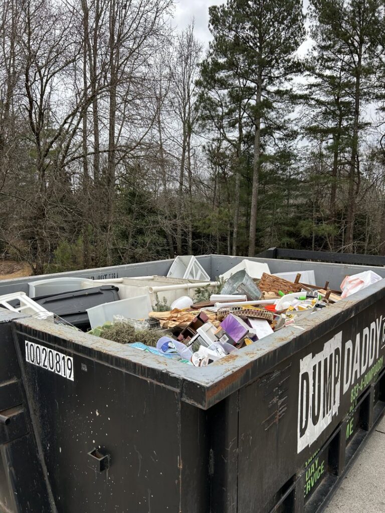 A Dump Daddy dumpster filled with various items for junk removal in Buford, GA.
