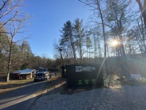 A Dump Daddy dumpster placed in a wooded residential area for junk removal in Buford, GA.