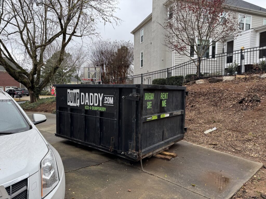 A Dump Daddy dumpster placed on a residential driveway, ready for junk removal in Buford, GA.