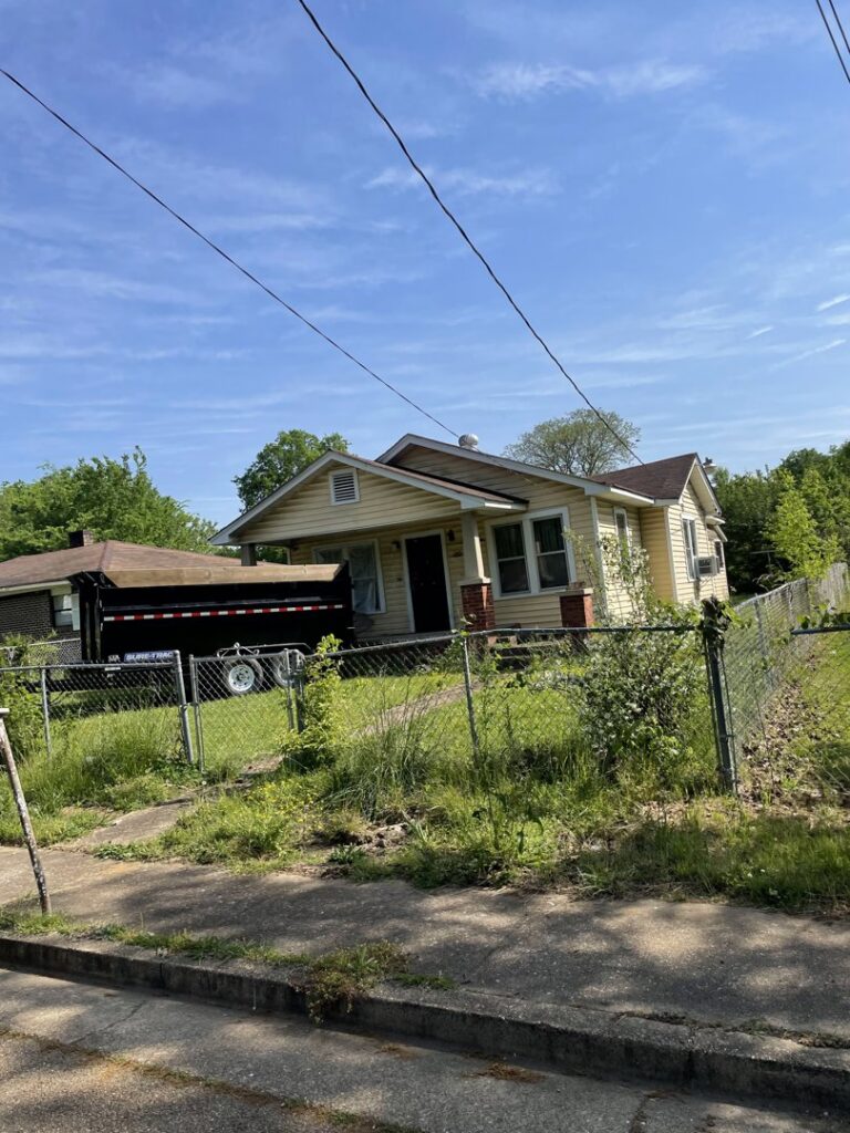 A dump trailer from Mobile Dumpster Solutions parked at a residential house for junk removal in Chattanooga, TN.