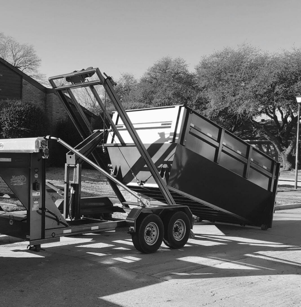 A dump trailer being delivered or picked up for a general junk removal job by Trashco DFW in Dallas, TX