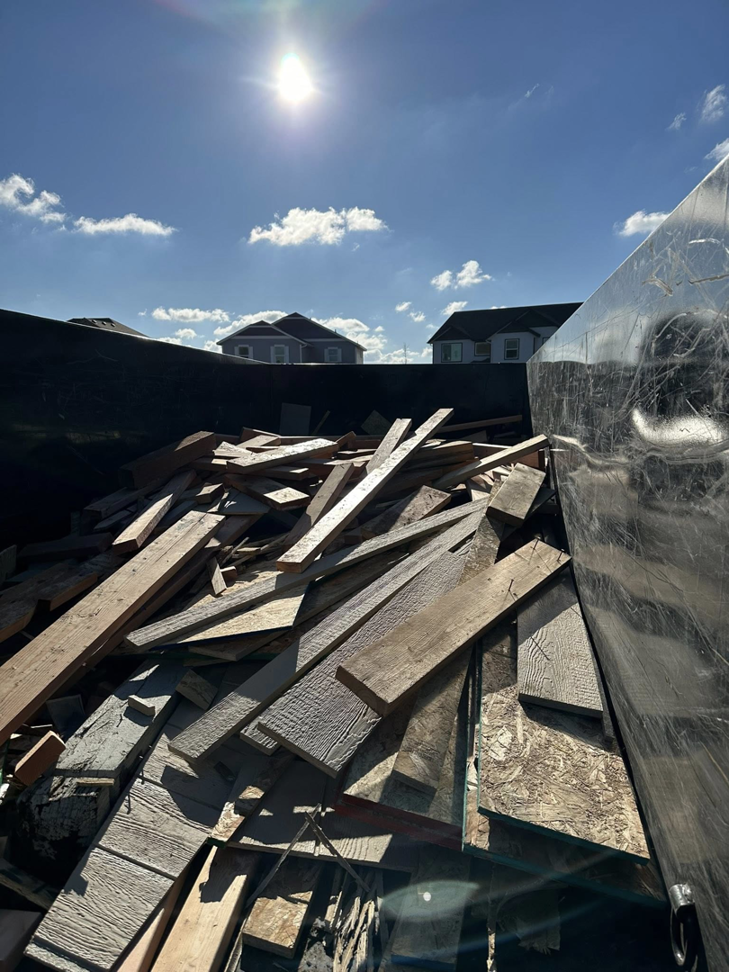 A dump trailer filled with wooden debris and lumber from a light demolition or junk removal project by Timber Moose Dynamics LLC in Spokane, WA.