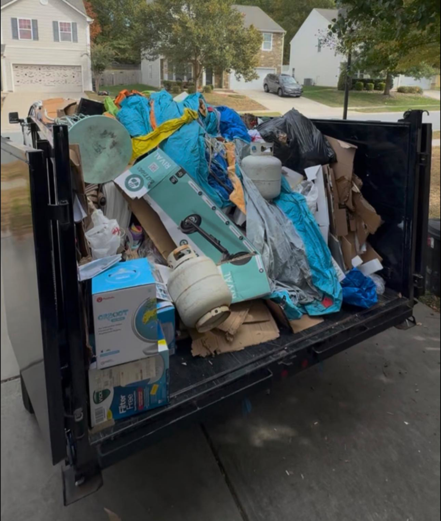 A Junkjet dump trailer completely full of various household junk items after a removal job in Charlotte, NC.