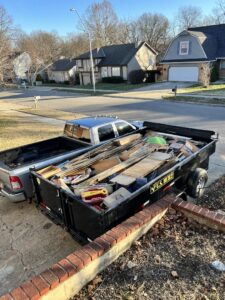 A dump trailer filled with construction debris and household junk, ready for removal by D's Dumpster Rentals, Overland Park, KS.