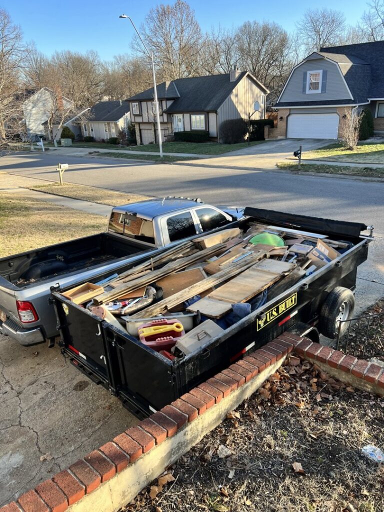 A dump trailer filled with construction debris and household junk, ready for removal by D's Dumpster Rentals, Overland Park, KS.