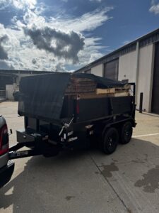 A dump trailer filled with wood debris and construction waste for removal by Junk Brothers in Louisa, KY.