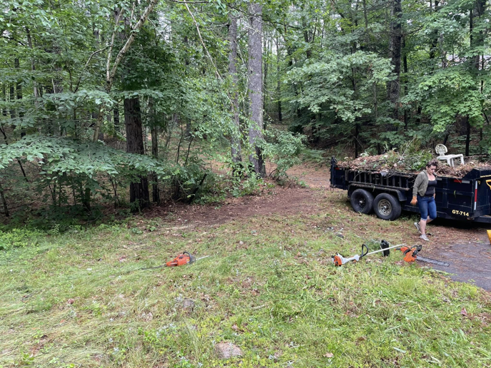 A dump trailer filled with brush and yard waste, ready for hauling by Mr. Property Service in Sanford, ME.