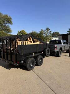 A dump trailer loaded with wooden pallets and other debris for removal by Junk Brothers in Louisa, KY.