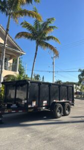 A dump trailer used for tree debris removal on a street in Fort Lauderdale, FL, by Tree service of south florida inc.