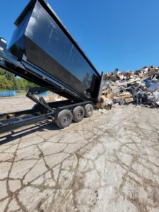A Silverback Dumpster Rentals dump trailer unloading construction debris at a job site in LaBelle, FL.