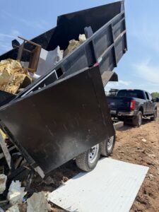 A dump trailer unloading construction waste and debris at a disposal site for Navarro Demo LLC in Rockville, MD