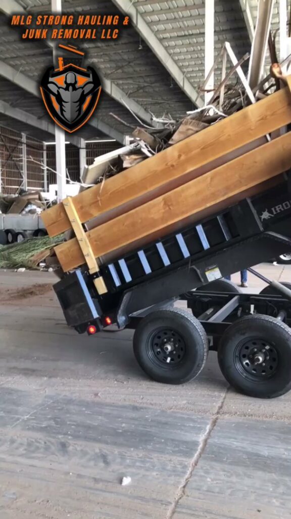 A dump trailer unloading a large pile of debris, showcasing active junk removal services by MLG Strong Hauling & Junk Removal LLC in Henderson, NV.