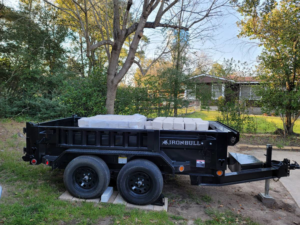 A dump trailer loaded with bags of construction materials, ready for a project by Team512 in Austin, TX