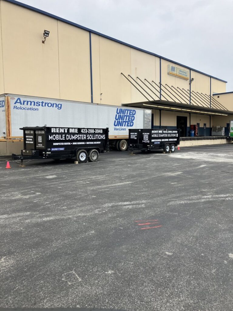 Two dump trailers from Mobile Dumpster Solutions parked at a commercial warehouse in Chattanooga, TN.