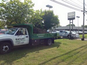 A Ratliff Landscape and Tree Service LLC dump truck filled with mulch, parked on a job site in Murfreesboro, TN