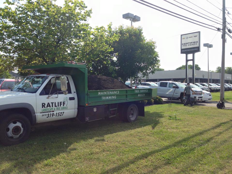 A Ratliff Landscape and Tree Service LLC dump truck filled with mulch, parked on a job site in Murfreesboro, TN
