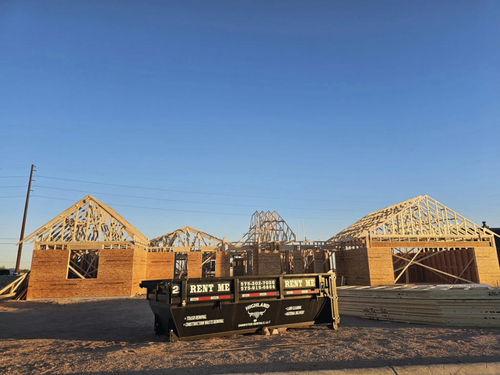A Highland Dumpster Rentals LLC dumpster at a residential construction project in Las Cruces, NM.