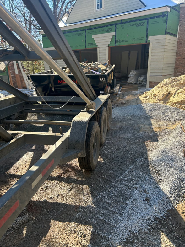 A dumpster on a trailer being used at a residential construction site by HD Waste Services in Chattanooga, TN.