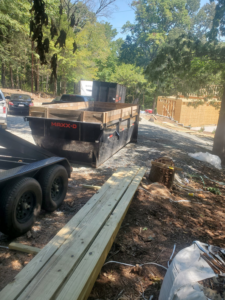 A black dumpster trailer parked at a construction site, ready for debris removal by Standard Dumpster LLC in Rock Hill, SC.