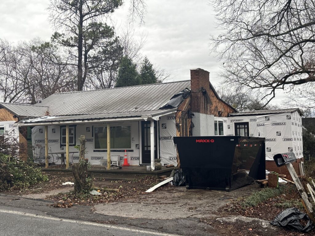 A dumpster placed at a house undergoing renovation for debris removal by Mobile Dumpster Solutions in Chattanooga, TN.