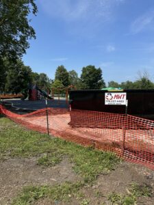 An MWT Dumpster and Hauling Services dumpster placed at a playground renovation site for debris removal in Morris, IL.