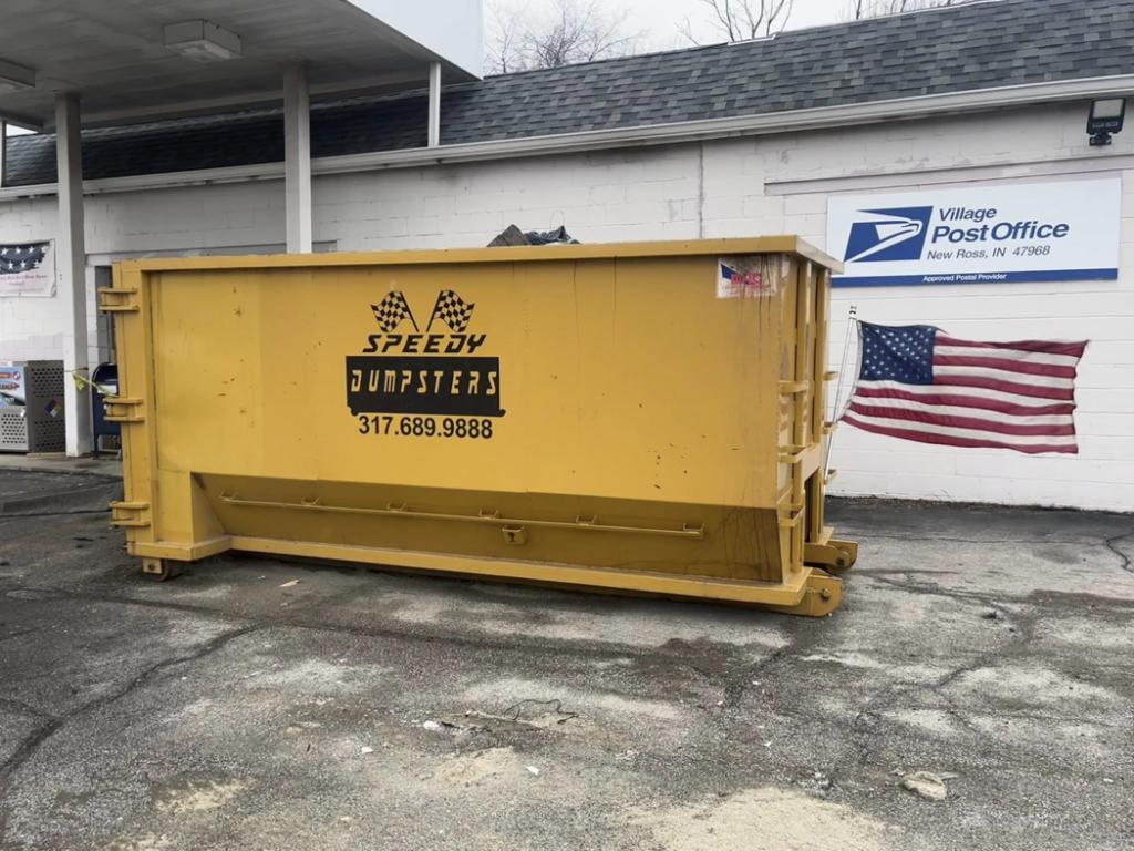 A Speedy Dumpsters roll-off container placed in front of a commercial building in Brownsburg, IN.