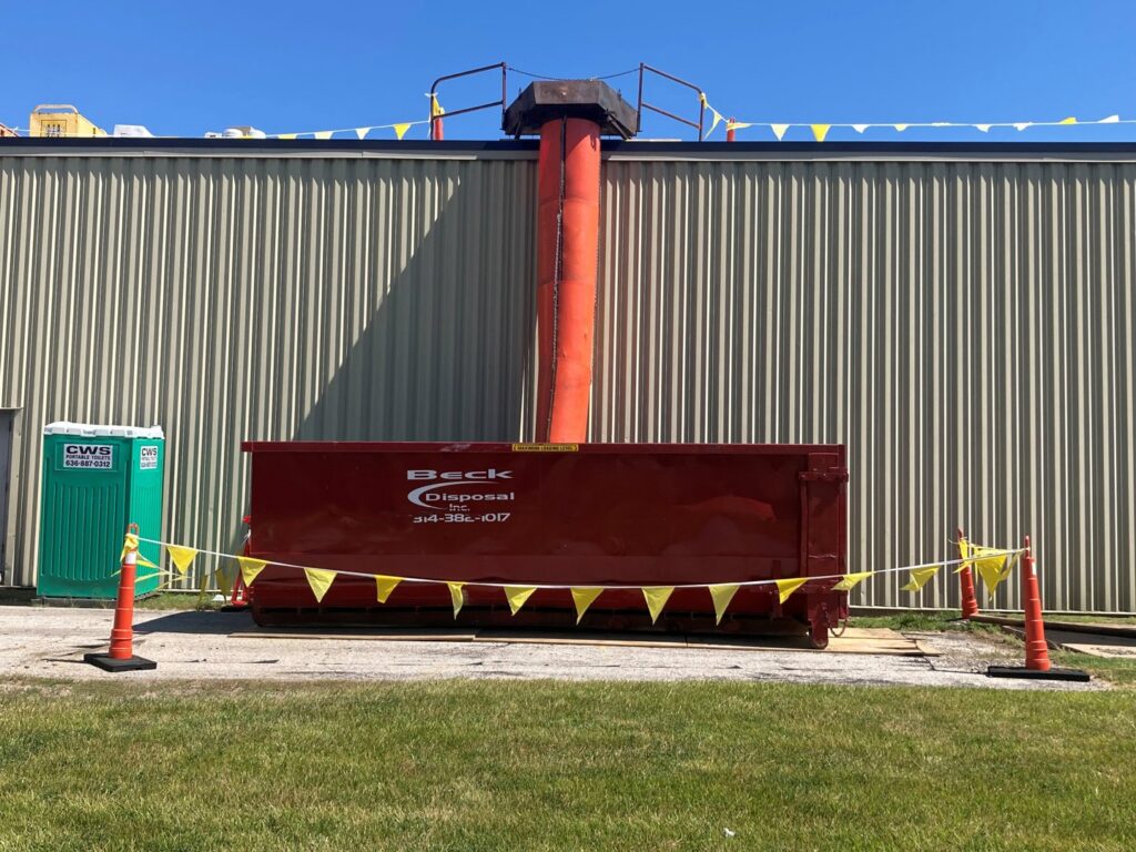 A Beck Disposal Inc. roll-off dumpster being loaded with construction debris in St. Louis, MO