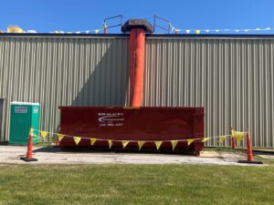A Beck Disposal Inc. roll-off dumpster being loaded with construction debris in St. Louis, MO