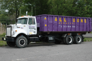 A large purple dumpster container on a truck from All Gone Removal Demolition & Junk Dumpster Containers in Toms River, NJ.